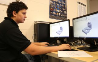 Mechanical Design and Engineering Technology student working on a project on his computer