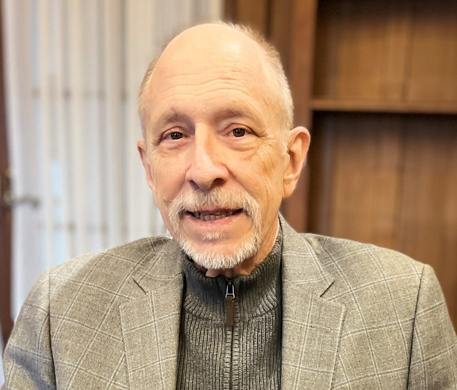 Photo of Interim Executive Director Freeman Burr sitting in office chair